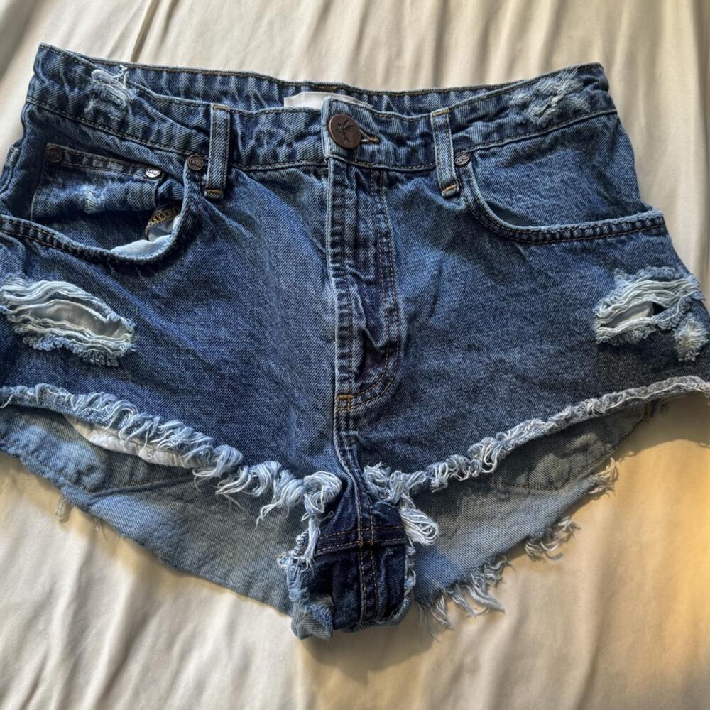 Micro blue denim shorts with frayed hem and distressed details